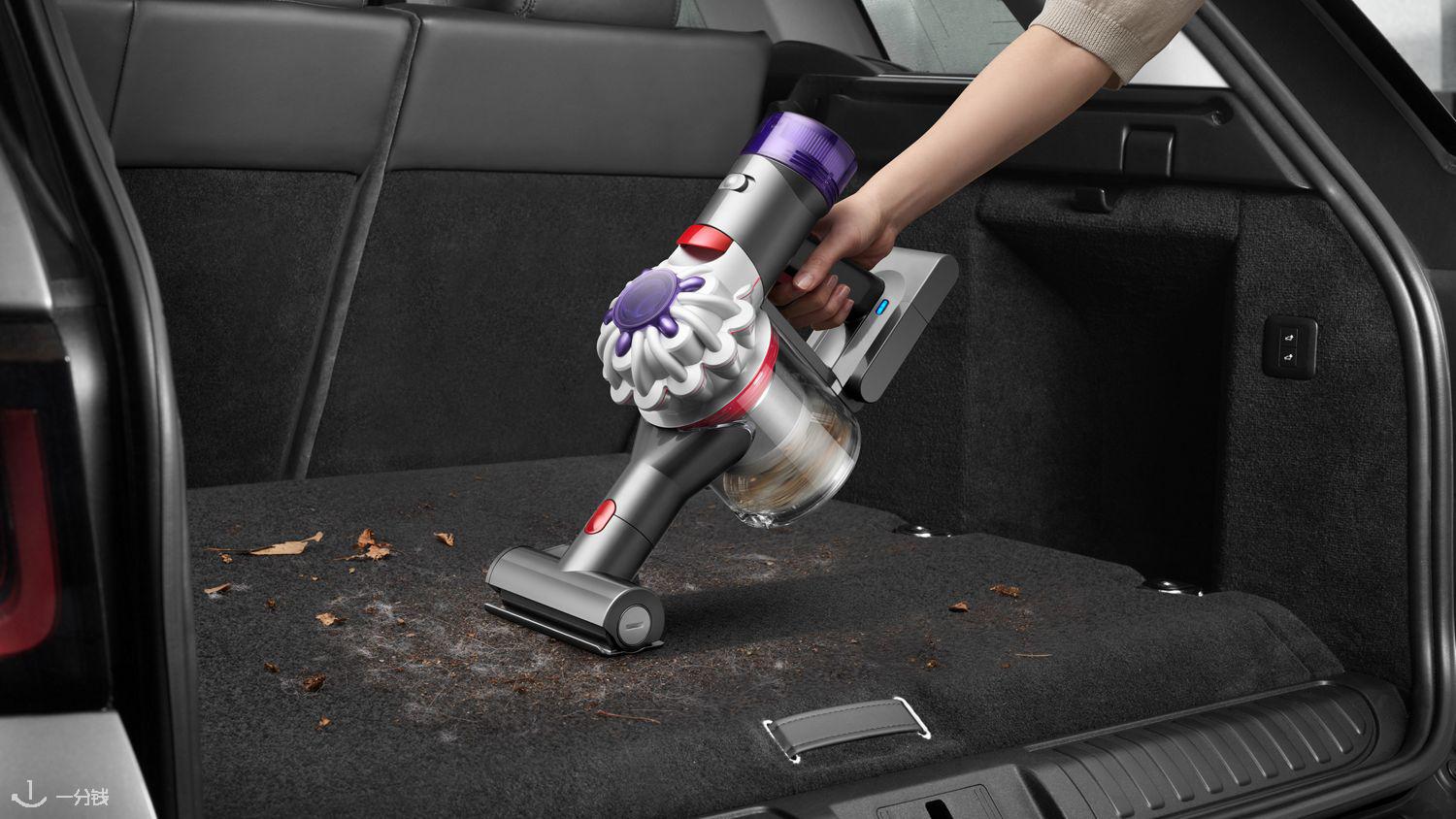 The Dyson Car+Boat handheld vacuum with the Mini motorised tool cleaning dirt, dust and hair from a car.